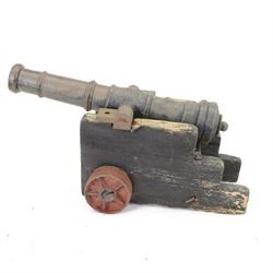 Victorian model of a ship's cannon, the ringed iron barrel with flared muzzle upon an
woo...