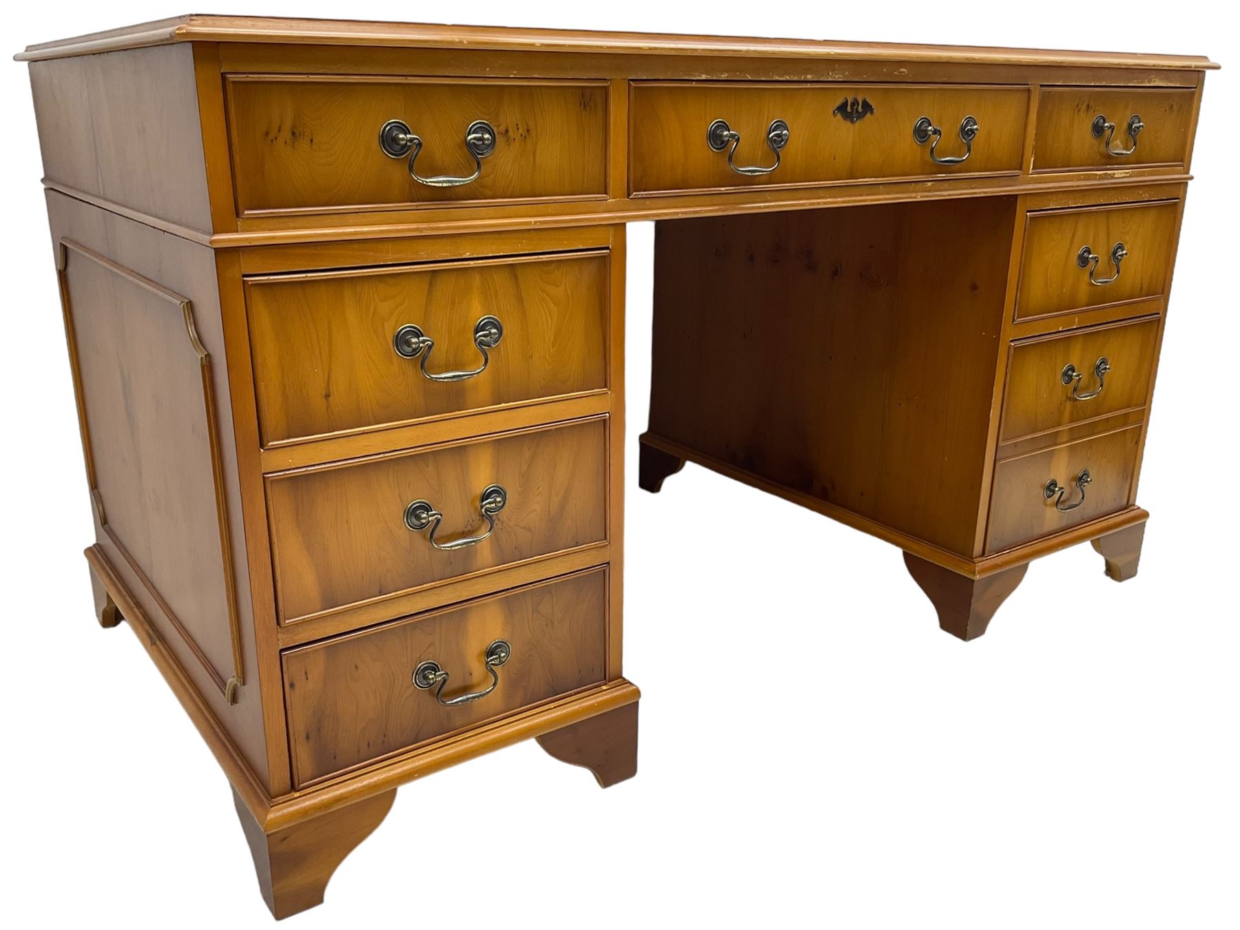 Georgian design yew wood twin pedestal desk, moulded rectangular top over nine cock-beaded drawers, on bracket feet