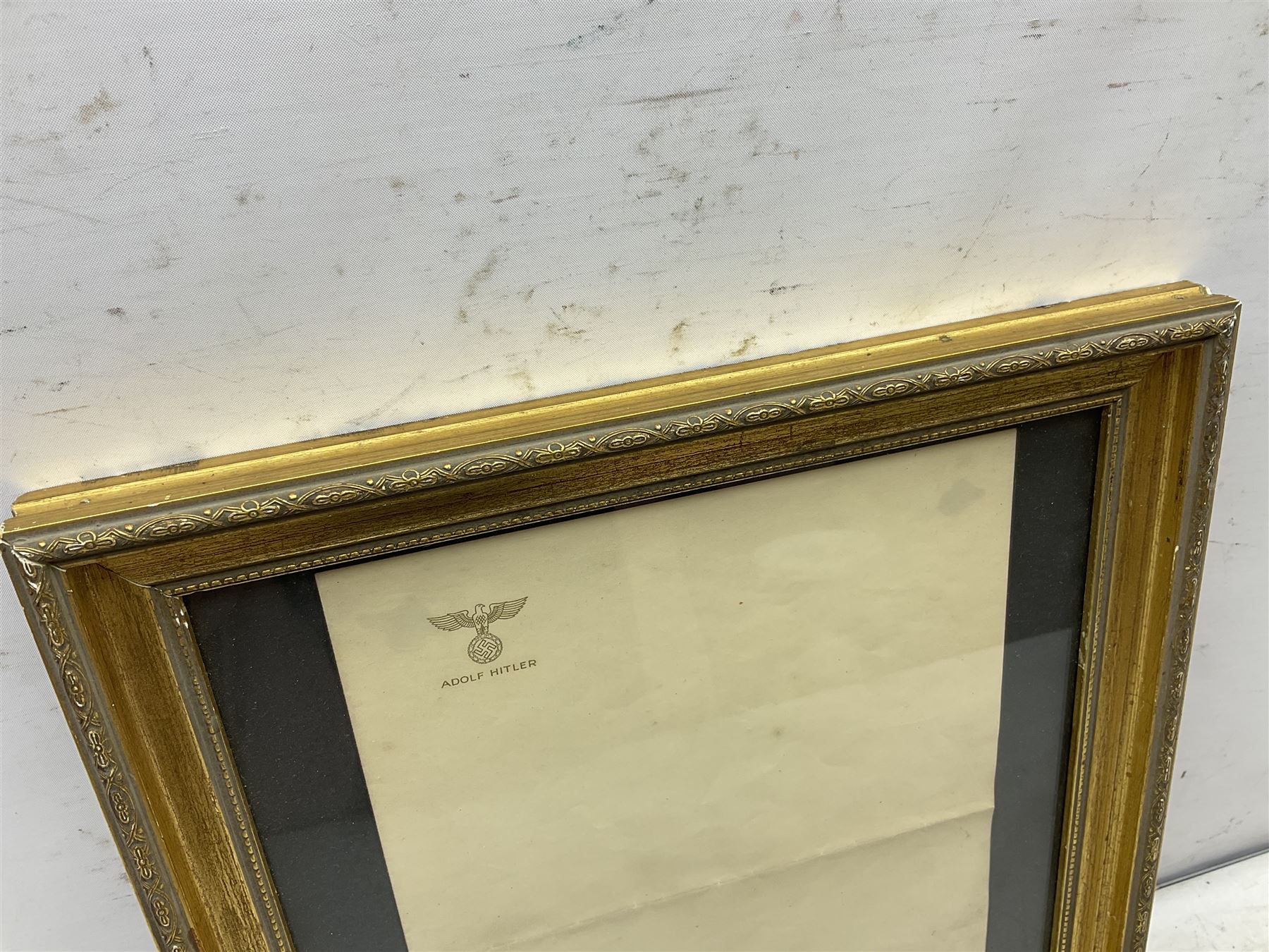 Adolf Hitler - single sheet of unused note paper embossed in gilt to the top left corner with the national eagle and ADOLF HITLER 29.5 x 20.5cm; in later gilt frame