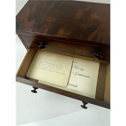 19th century mahogany miniature chest of drawers, with three graduating drawers, each with wooden handles, with inlaid shaped front and upon four bracket feet, H24cm