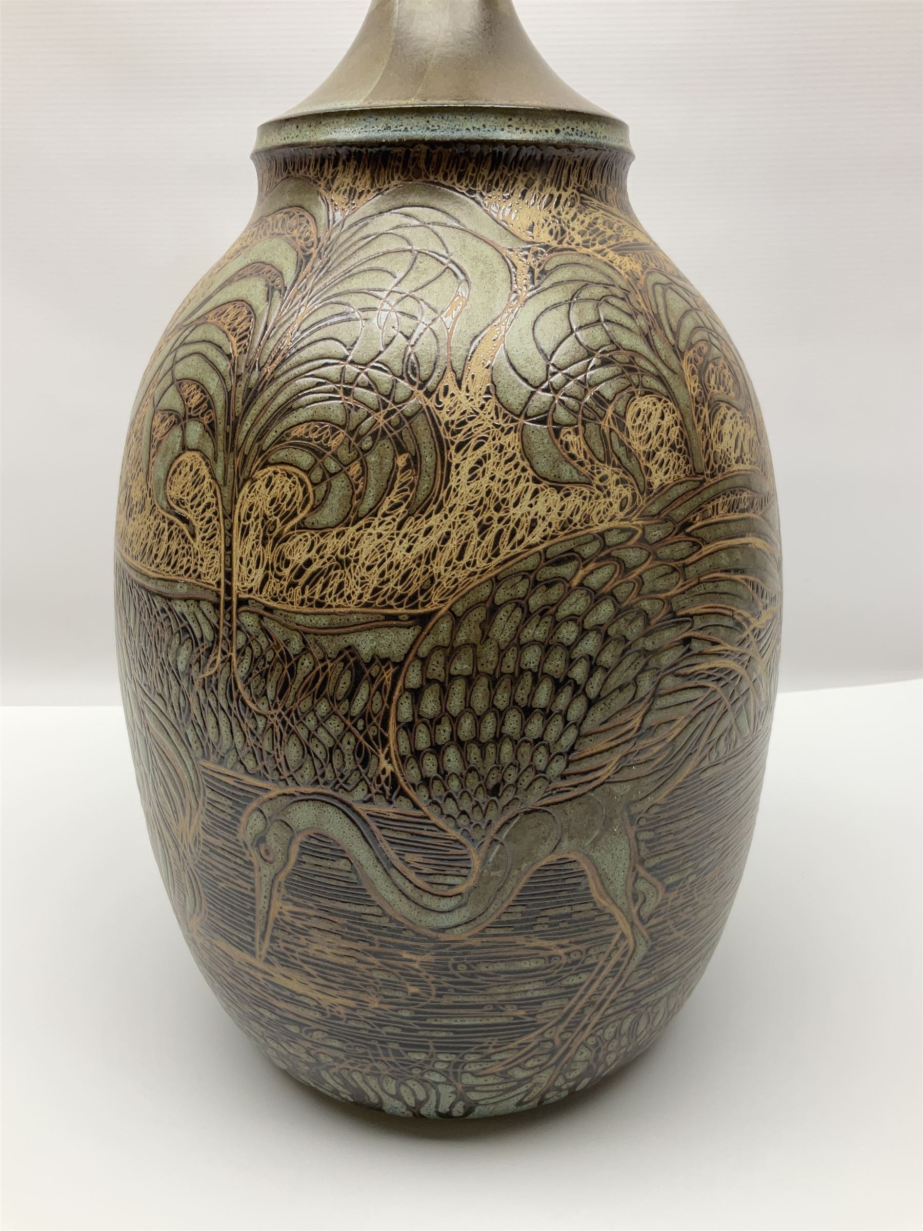 John Egerton (c1945-): studio pottery stoneware lamp base, decorated with cranes in a riverscape upon a mottled brown ground, H51cm