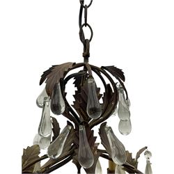 Early 20th century wrought metal chandelier, of scrolled form with six branches, decorated with leafage and glass pendants 