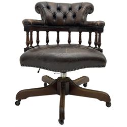 Georgian design tub-shaped office desk chair, upholstered in buttoned brown leather, on five spoke base with castors 