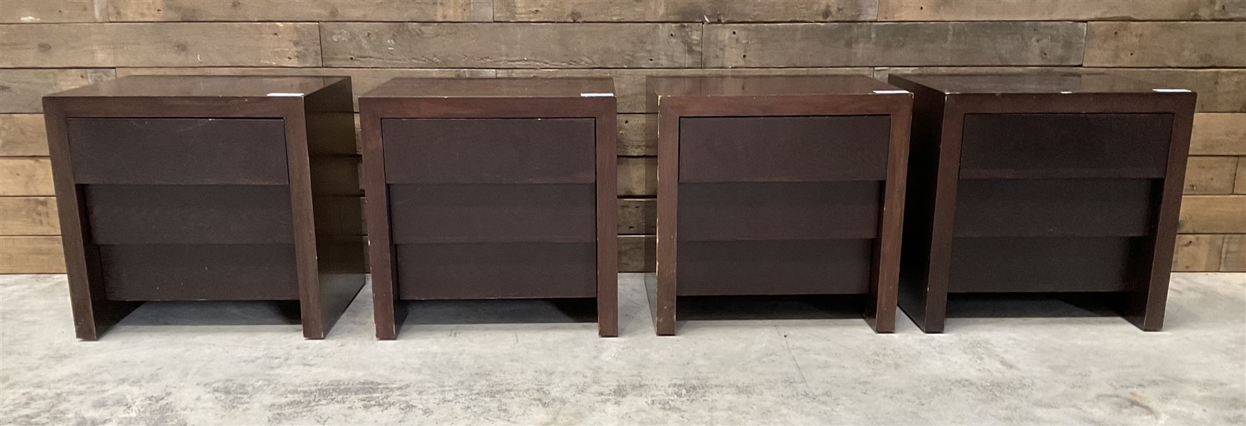 Four rosewood bedside chests, fitted with three stepped soft-close drawers