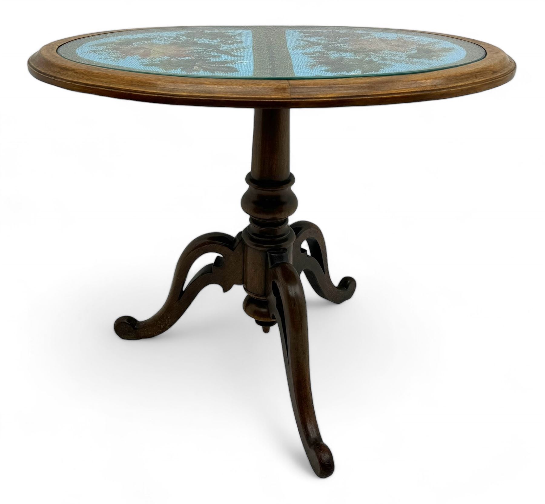 Victorian mahogany pedestal table, oval top inlaid with tapestry under glass, turned central pedestal with pointed finial, on three carved scroll supports