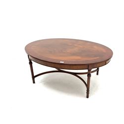 Late 20th century mahogany coffee table, oval crossbanded top on turned supports joined by curved x framed stretchers