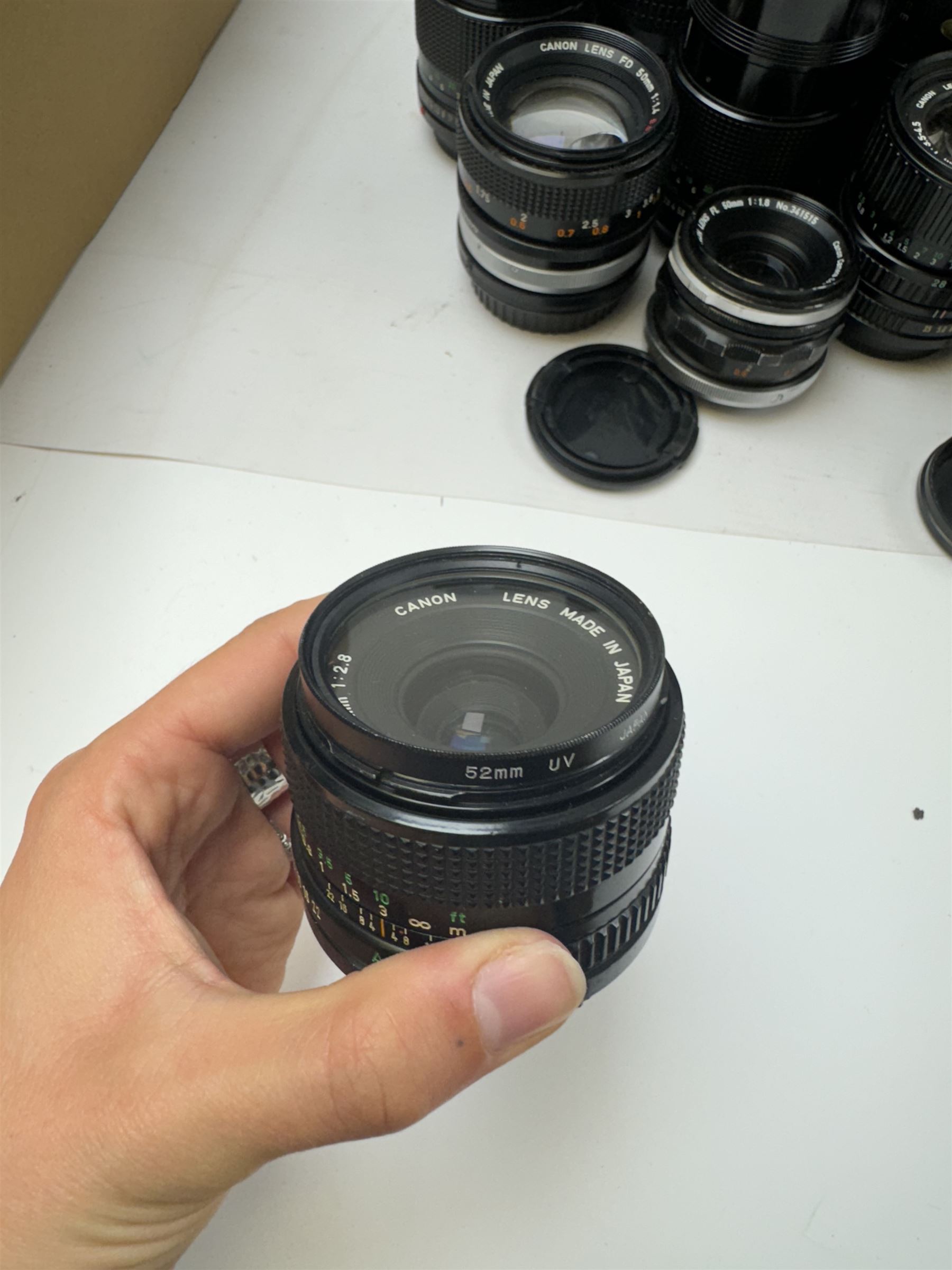 Seventeen Canon camera lenses, mostly FD examples, including 28-85mm 1:4 serial no, 49881, 35-105mm 1:3.5-4.5 serial no. 87632 and 135mm 1:2.8 serial no. 48336, one boxed