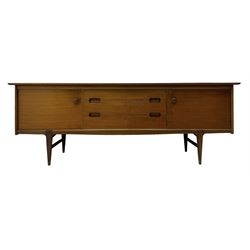 Younger - mid-20th century teak sideboard, rectangular top over three central drawers with recessed handles, flanked by two cupboard doors enclosing two shelves, on tapered supports joined by stretchers