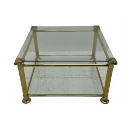 Mid 20th century brass and glass coffee table, square glass top with bevelled edges over undertier, supported by brass columns joined by crossbars, on circular feet