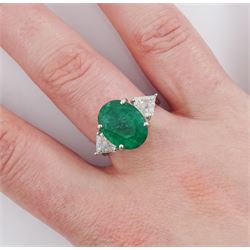 18ct white gold three stone oval cut emerald and trillion cut diamond ring, stamped, emerald approx 5.65 carat, total diamond weight approx 0.65 carat