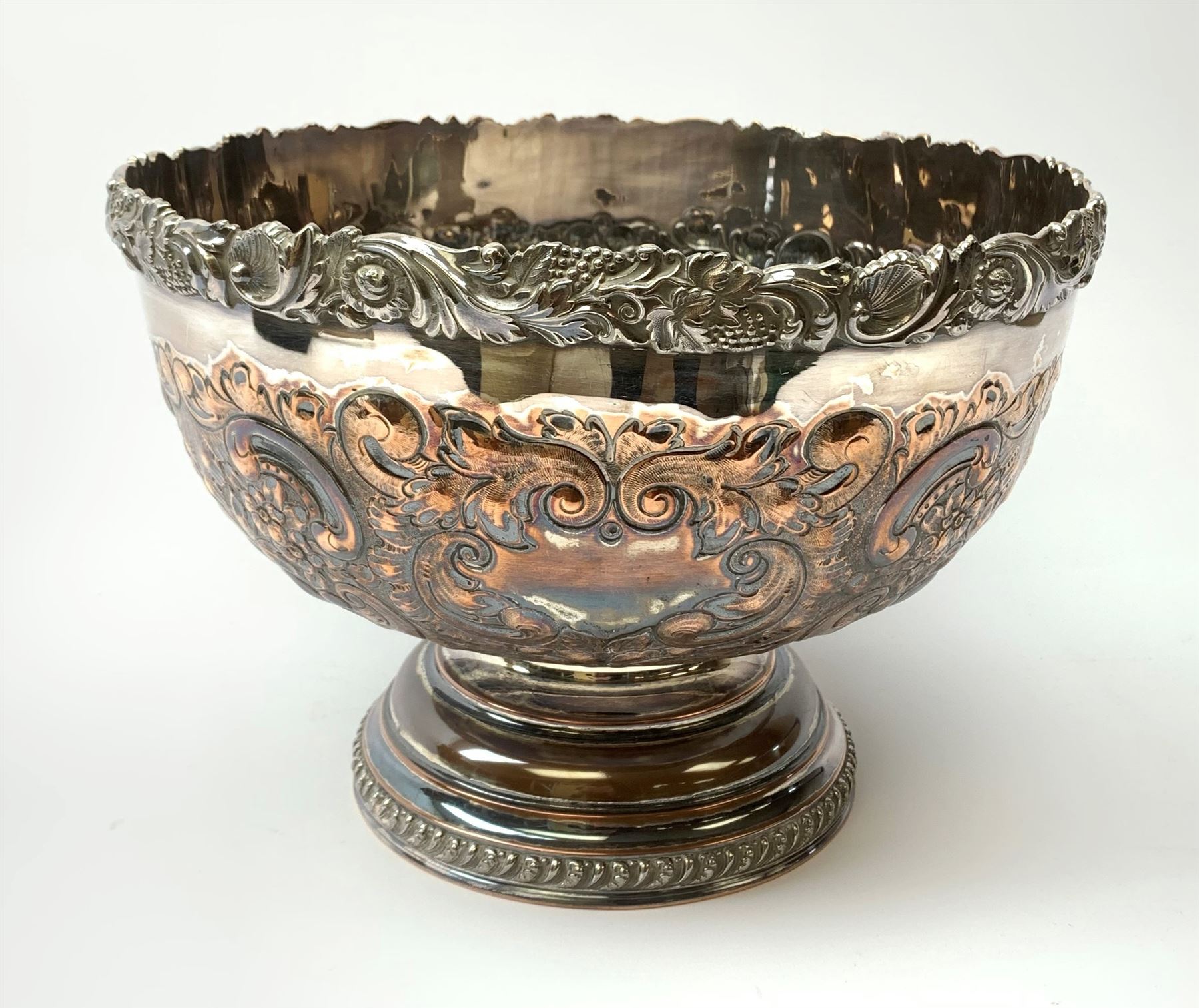 An early 20th century Barker Ellis Silver Co Ltd silver plated punch bowl, with embossed foliate detail to the body, applied rim with fruiting vines and acanthus leaves, and raised upon a stepped circular base with gadrooned detail, with MS shield mark beneath for Barker Ellis, H22c, D31cm. 