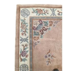 Chinese washed woollen pink ground rug, decorated with floral bouquets and Chinese symbols 