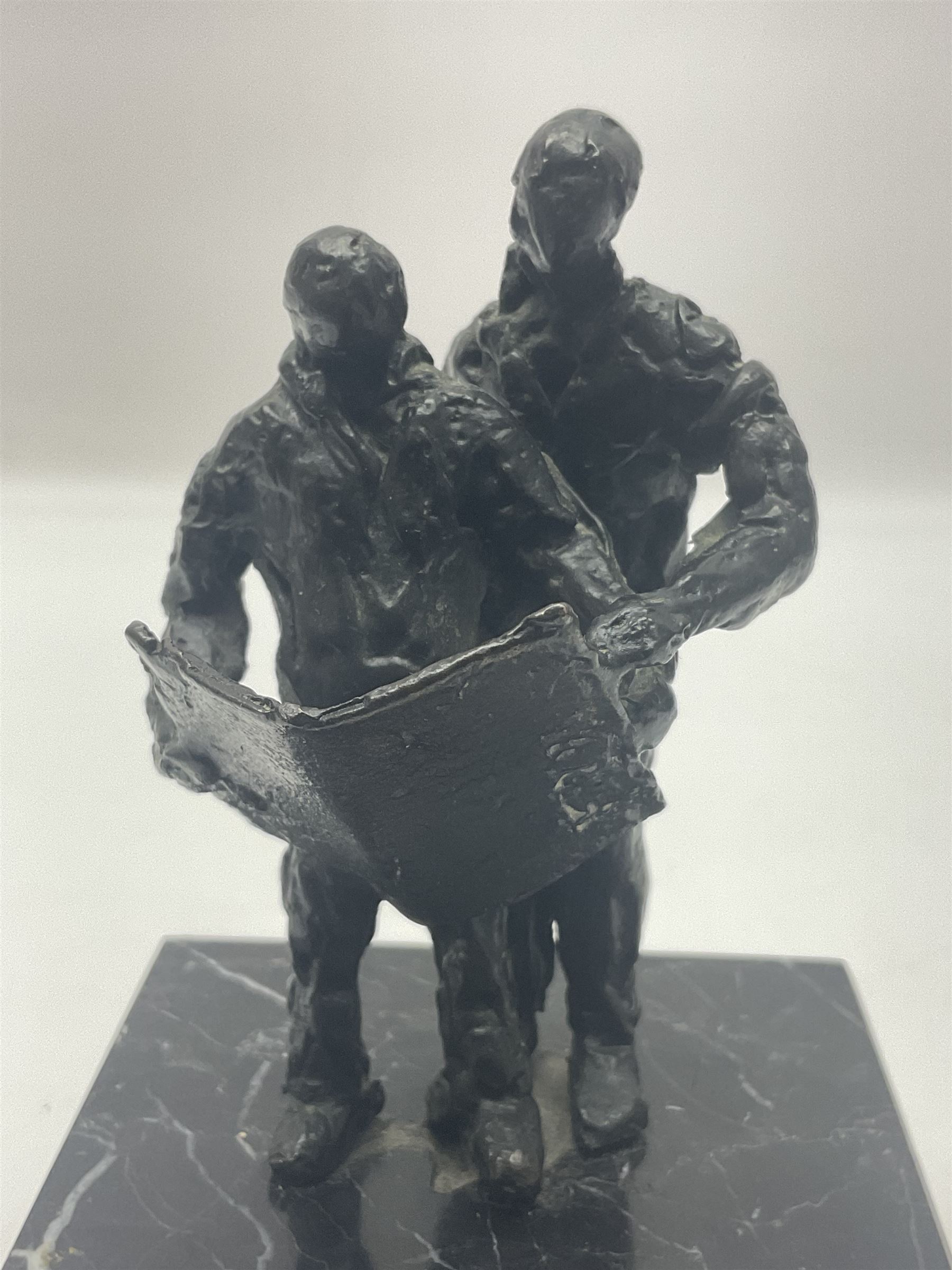 20th century bronze sculpture, modelled as two figures reading, upon a black and white marble base, H14cm