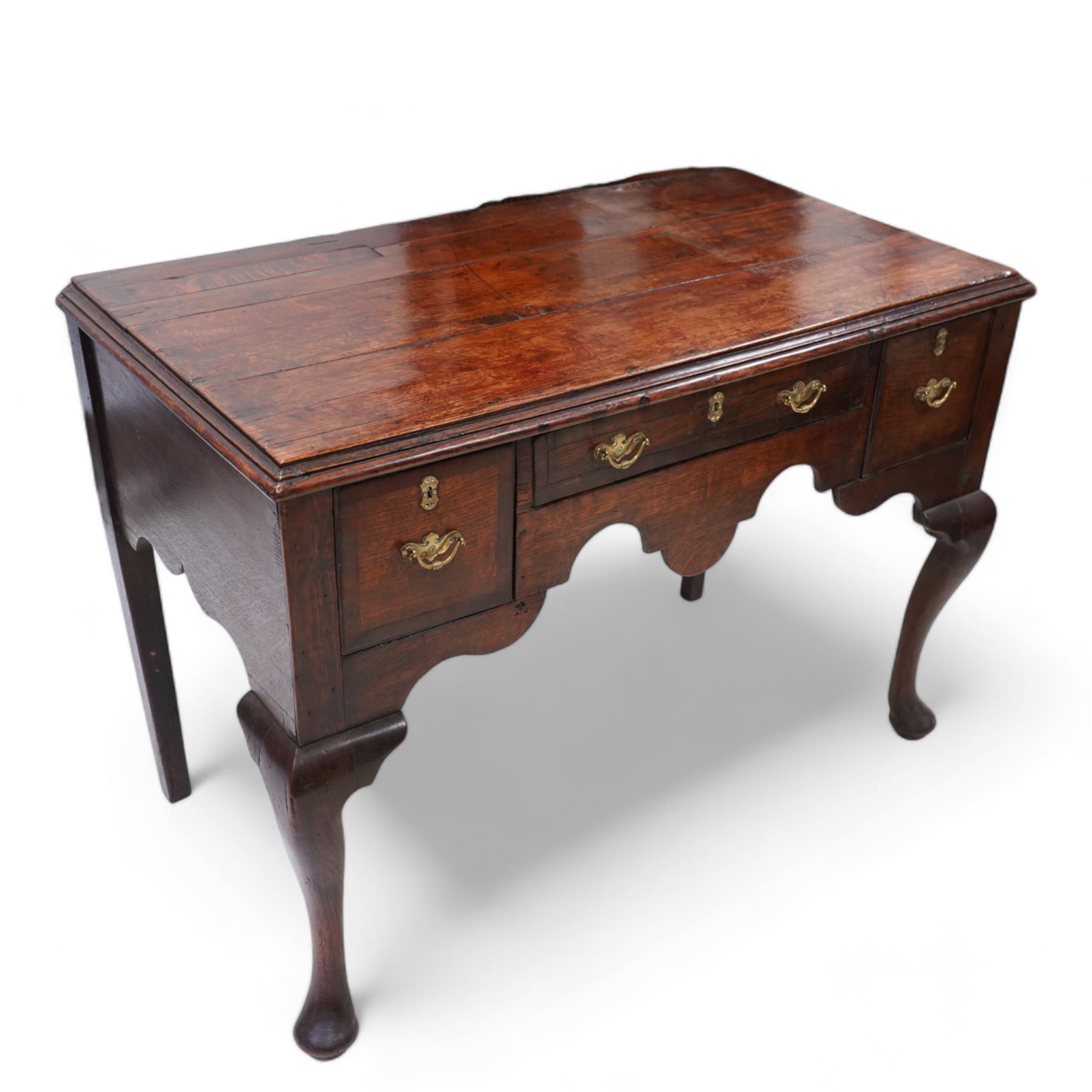 18th century oak low-boy, moulded rectangular top over three drawers and shaped apron, the mahogany banded drawer fronts fitted with shaped brass handles, on cabriole front supports and square tapering rear supports 