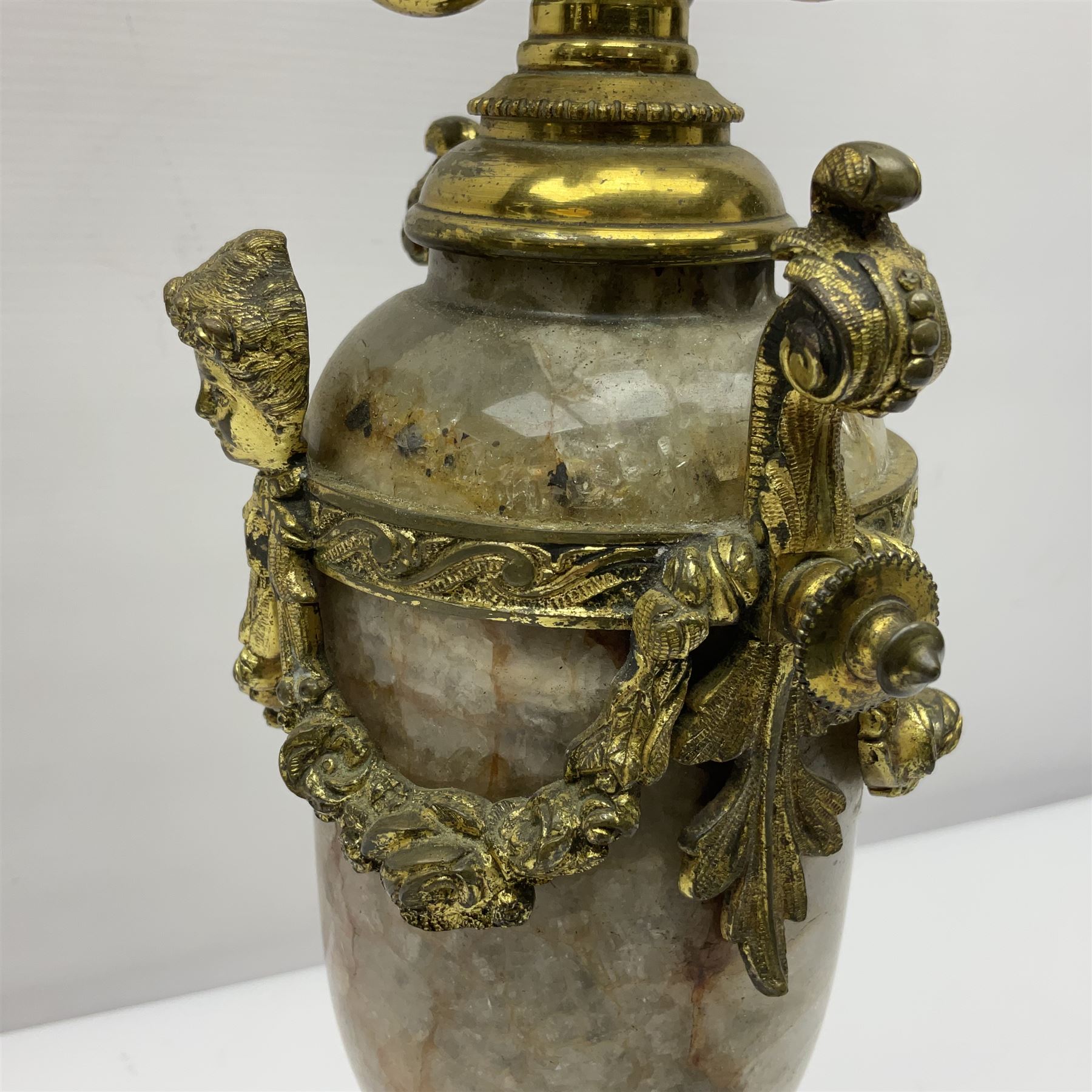 20th century five branch candelabra, with gilded floral garland and female mask decoration, to a marble effect resin urn and stepped base, upon four paw feet, H61cm