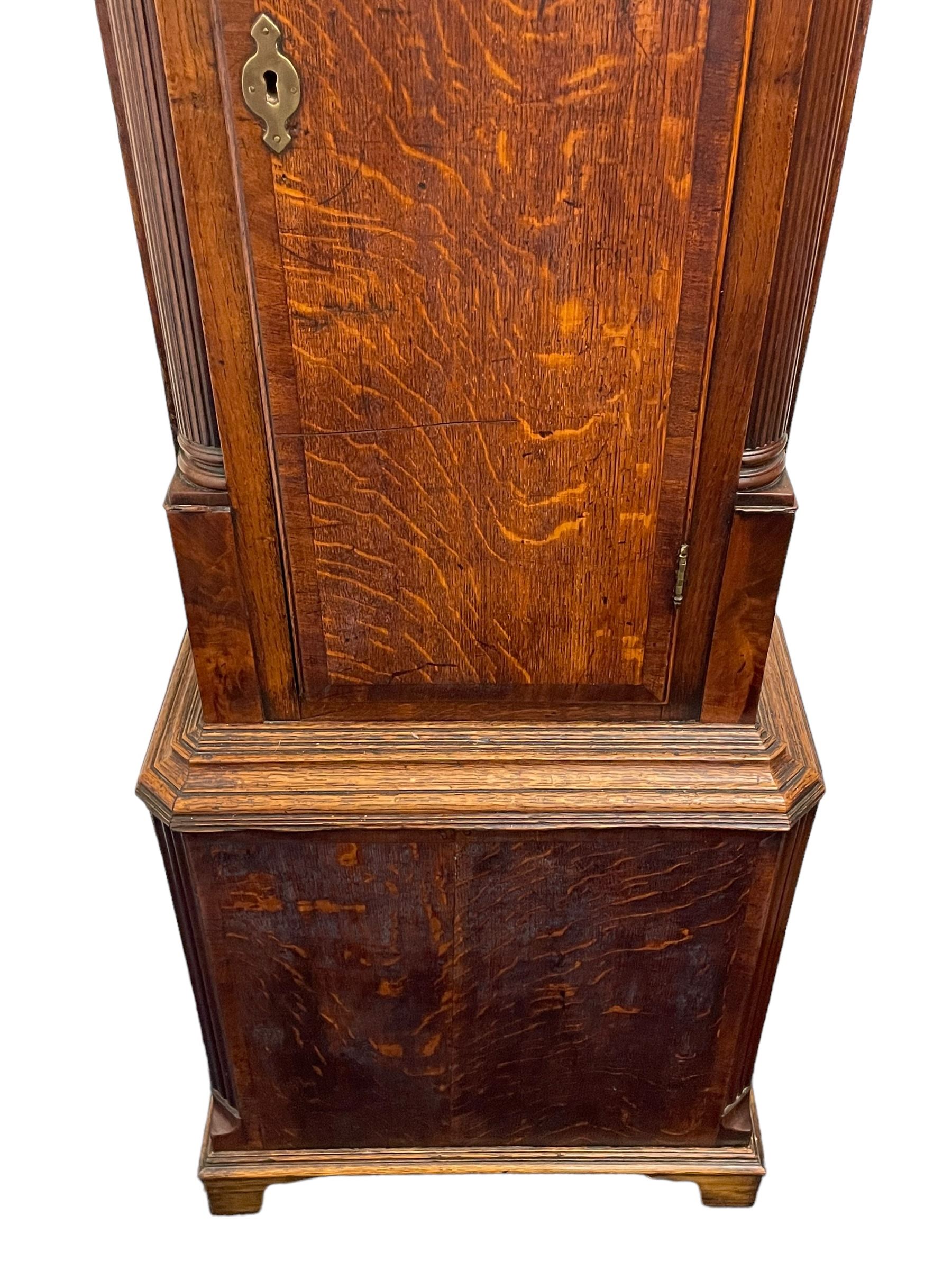 William Watson of  Blackburn (Lancs)  - late 18th century 8-day oak and mahogany cross banded longcase clock, with a flat top and open fretwork above, deep cornice with dogtooth moulding and frieze beneath, square hood door flanked by reeded pilasters with brass capitals, trunk with  reeded quarter columns, long trunk door with concave corners on a plinth with canted corners on bracket feet, brass dial with cast brass spandrels, broad silvered chapter ring with Roman numerals and five-minute Arabic's, a profusely engraved and silvered dial centre with seconds dial, matching steel hands and calendar aperture, hourly rack striking movement with a recoil anchor escapement. With weights, pendulum and key. 
William Watson of Northgate, Blackburn, is recorded as working c1770-1814 . As with this clock he frequently signed some of his clocks without a placename.