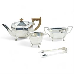 Silver three piece tea set of panel sided design, the tea pot with stained wood handle and lift Sheffield 1940 Maker Edward Viner, and a pair of 19th century silver sugar tongs