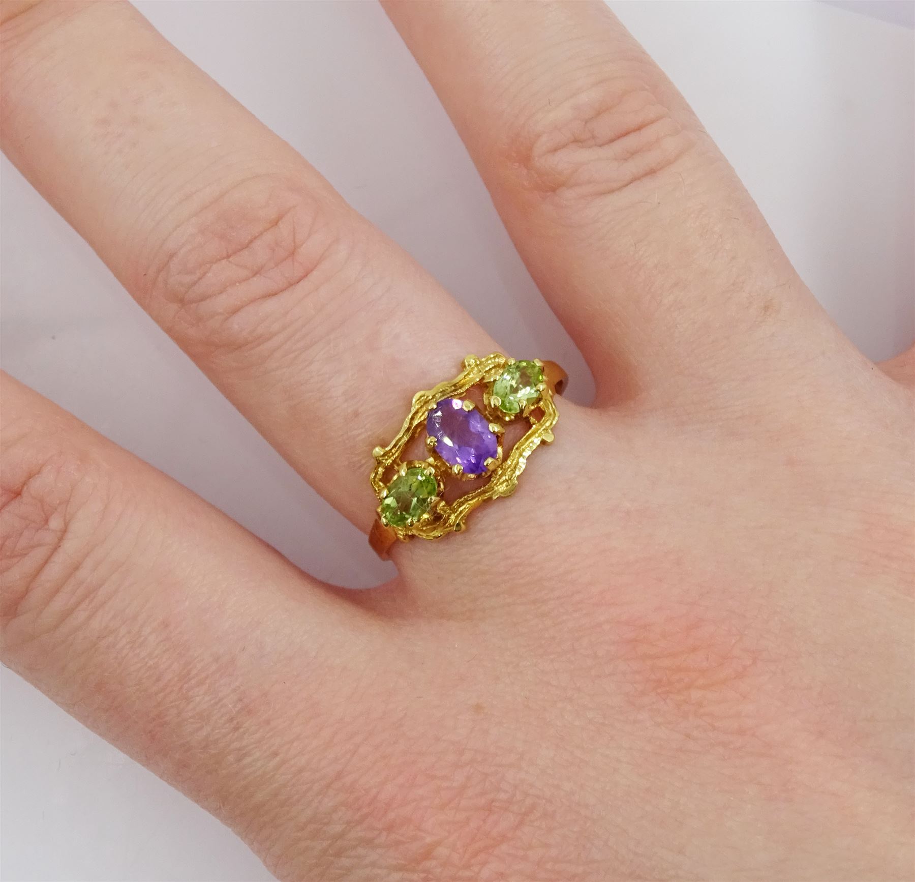 Silver-gilt three stone peridot and amethyst ring, stamped Sil