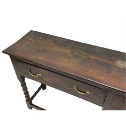 18th century oak dresser base, rectangular top, fitted with two drawers with moulded facia edges and brass swan neck handles, raised on turned front supports united by stretchers