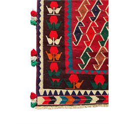 Southwest Persian Qashqai Kilim crimson ground rug, decorated with a repeating geometric pattern of interlocking diamond motifs in red, green, blue, and brown, enclosed by a deep brown border with stylised floral motifs and colourful fringe accents