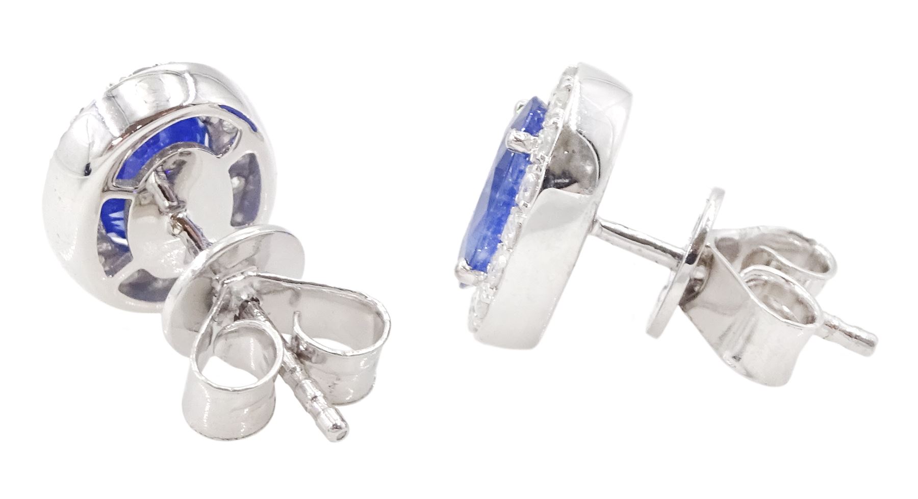 Pair of 18ct white gold oval cut sapphire and round brilliant cut diamond cluster stud earrings, hallmarked, total sapphire weight approx 2.05 carat