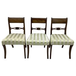 Set of six early 19th century mahogany dining chairs, bar cresting rail over pierced and shell carved middle rail, reed moulded uprights, upholstered seats on reed moulded sabre supports 