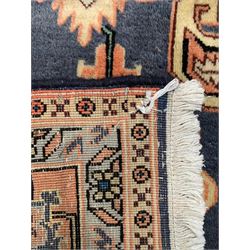 Persian ivory and peach ground, overall geometric design, the field with central star medallion surround stylised leaf motifs, guarded geometric design border