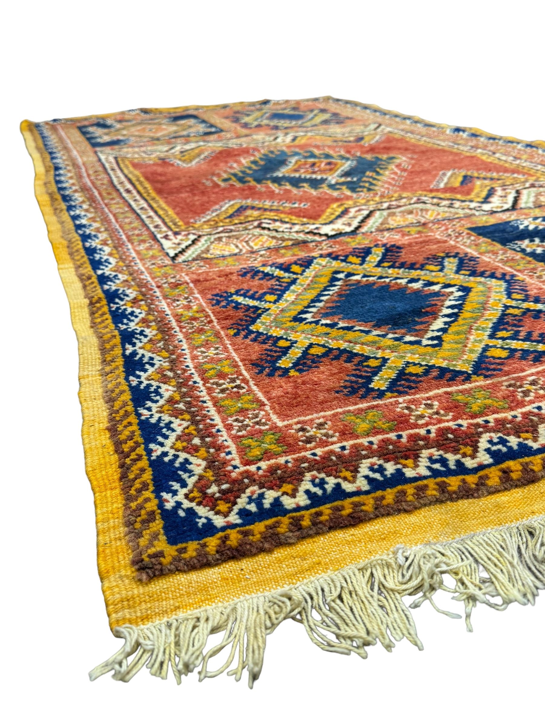 Persian Qashqai crimson ground rug, the field with central indigo and yellow medallion with geometric motifs, flanked by smaller medallions, border with repeating patterns (112cm x 200cm); Turkish Kazak light blue ground rug (109cm x 193cm); red ground runner with three octagonal medallions (69cm x 138cm)