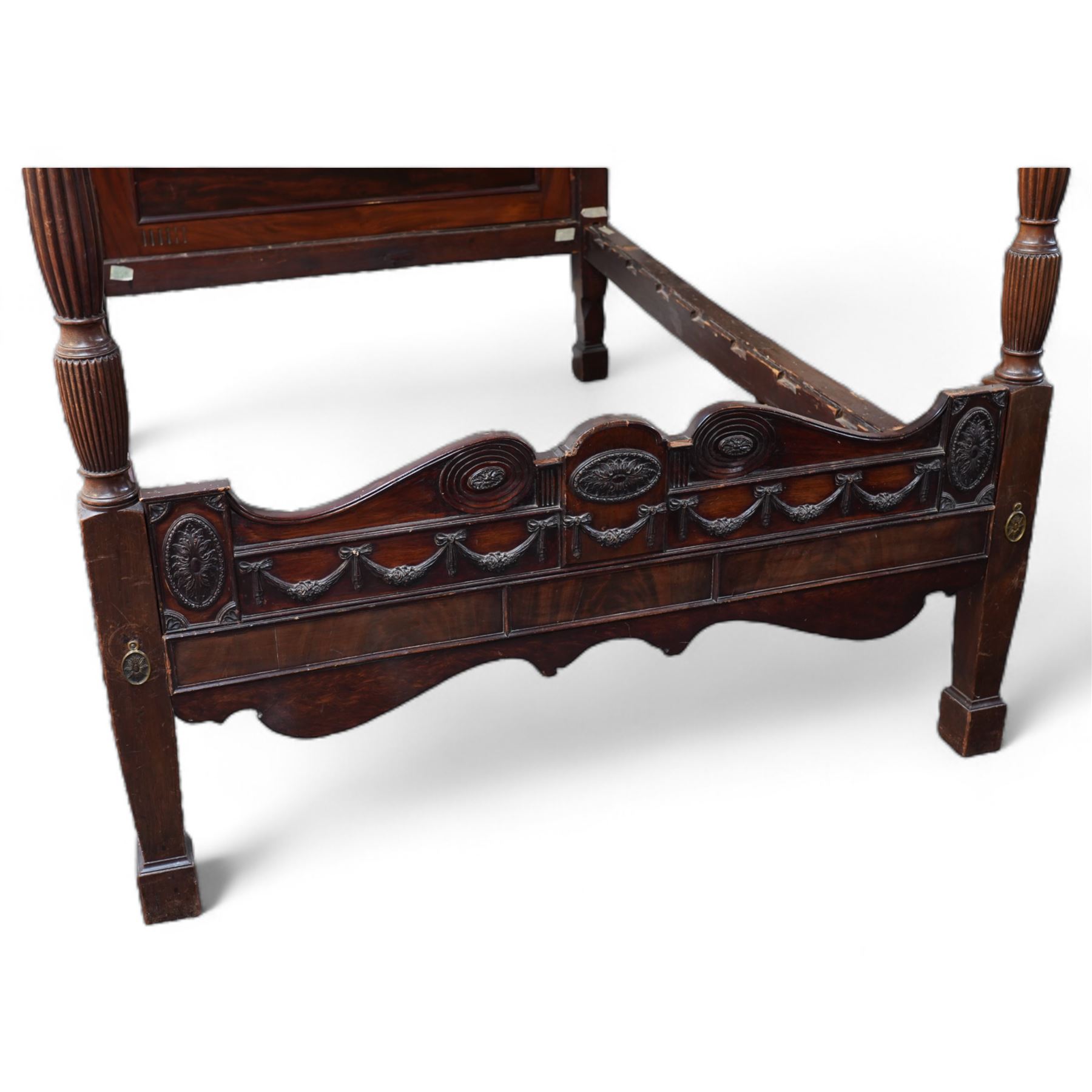 19th century and later Hepplewhite design mahogany four poster double bed, urn finials atop reeded and turned pilasters, head and footboard decorated with carved and moulded floral festoons and acanthus rosettes, shaped apron over shaped supports and square feet