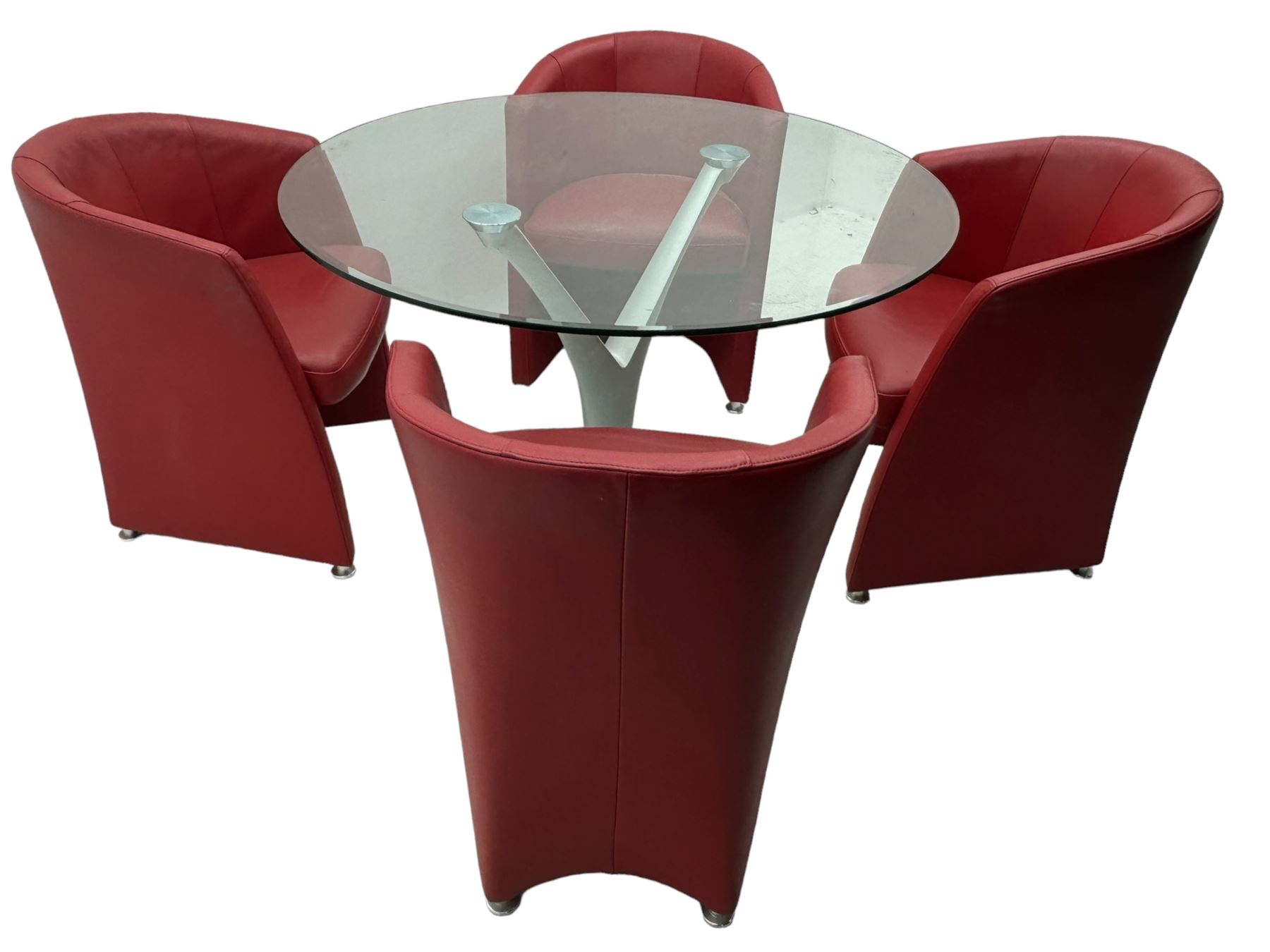 Rolf Benz glass dining table, circular bevelled glass top supported by central Y-shaped brushed metal column, terminating in circular glass base; four red leather tub chairs with curved backrests and vertical stitching, on round chrome feet (5)