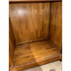 Large 20th century oak dresser, projecting cornice over open arched central section with two shelves, flanked by two panelled cupboards with two shelves, lower section with three drawers above three cupboards, on stile supports 