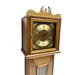 20th century Grandmother clock in a bespoke hand made case with a two-train weight driven German movement striking the hours and half hours on three gong rods, dial with spun brass chapter ring with Roman numerals, pierced steel hands and cherub spandrels, glazed door displaying brass cased weights and pendulum.