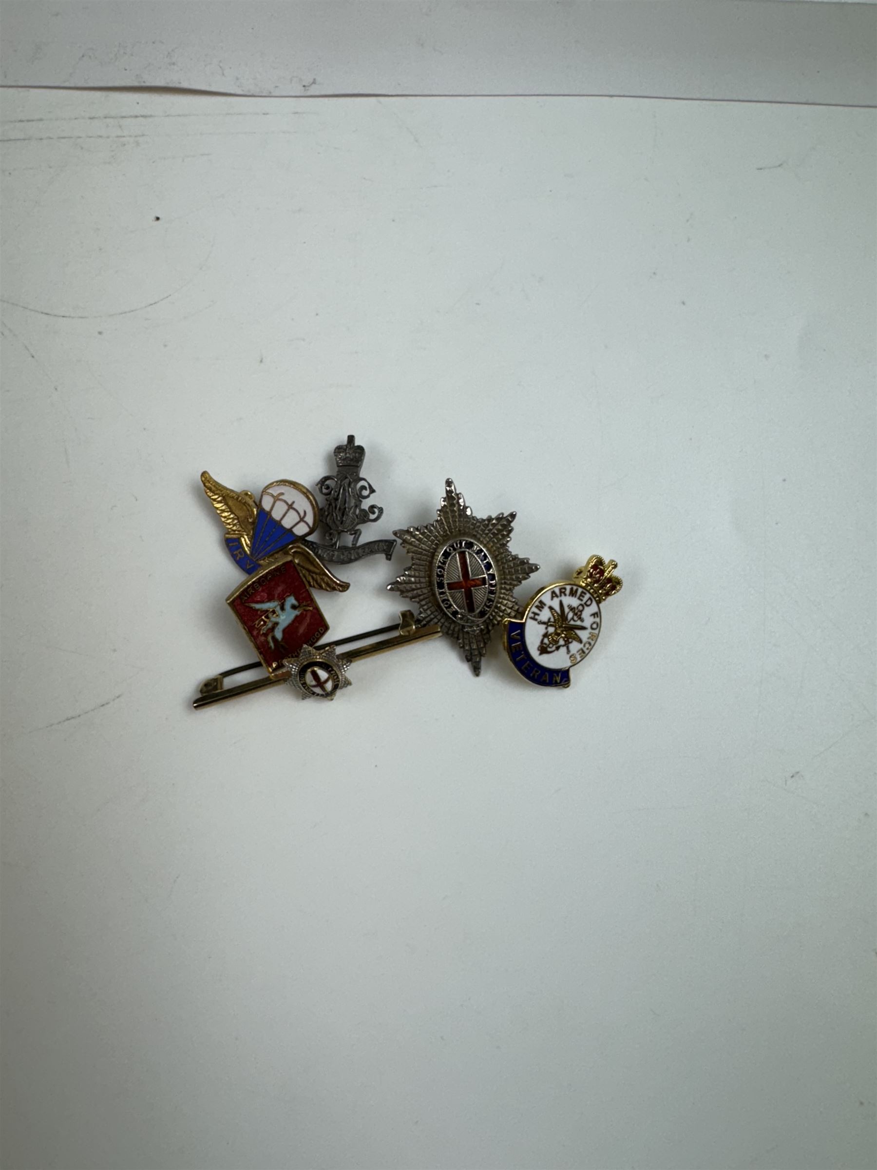 Six badges including 9ct gold and silver order of the garter stars, silver 97th Battery Lawsons Company RA badge etc