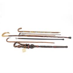 Seven walking sticks, including four silver mounted examples, and carved African example