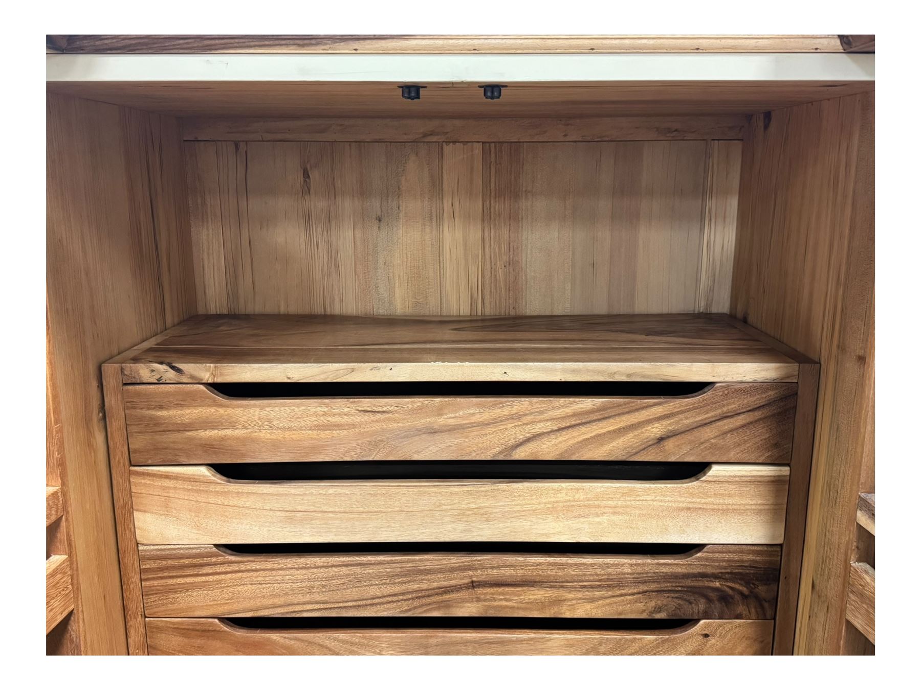 Hardwood and cream painted kitchen larder cupboard, sloped pediment over two panelled doors, the interior fitted with slides, drawers and storage shelves, two long drawers below, mounted by turned pilasters, on metal bound moulded plinth base