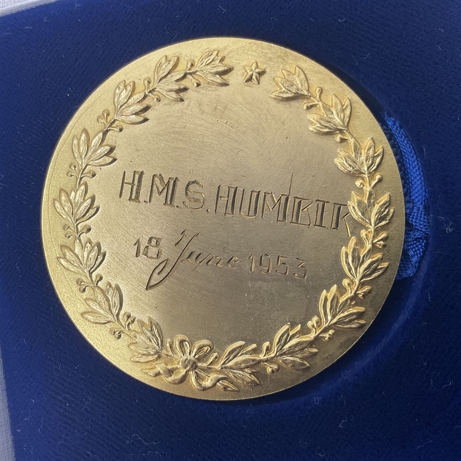 1950s gilt metal medallion, decorated in relief with the Coat of Arms of Oostende to one side and engraved HMS Humber together with a Royal Navy bosun's whistle, stamped with broad arrow and three ashtrays, one stamped HMS Birmingham and the other stamped Captain HMS Essington, medallion D5cm