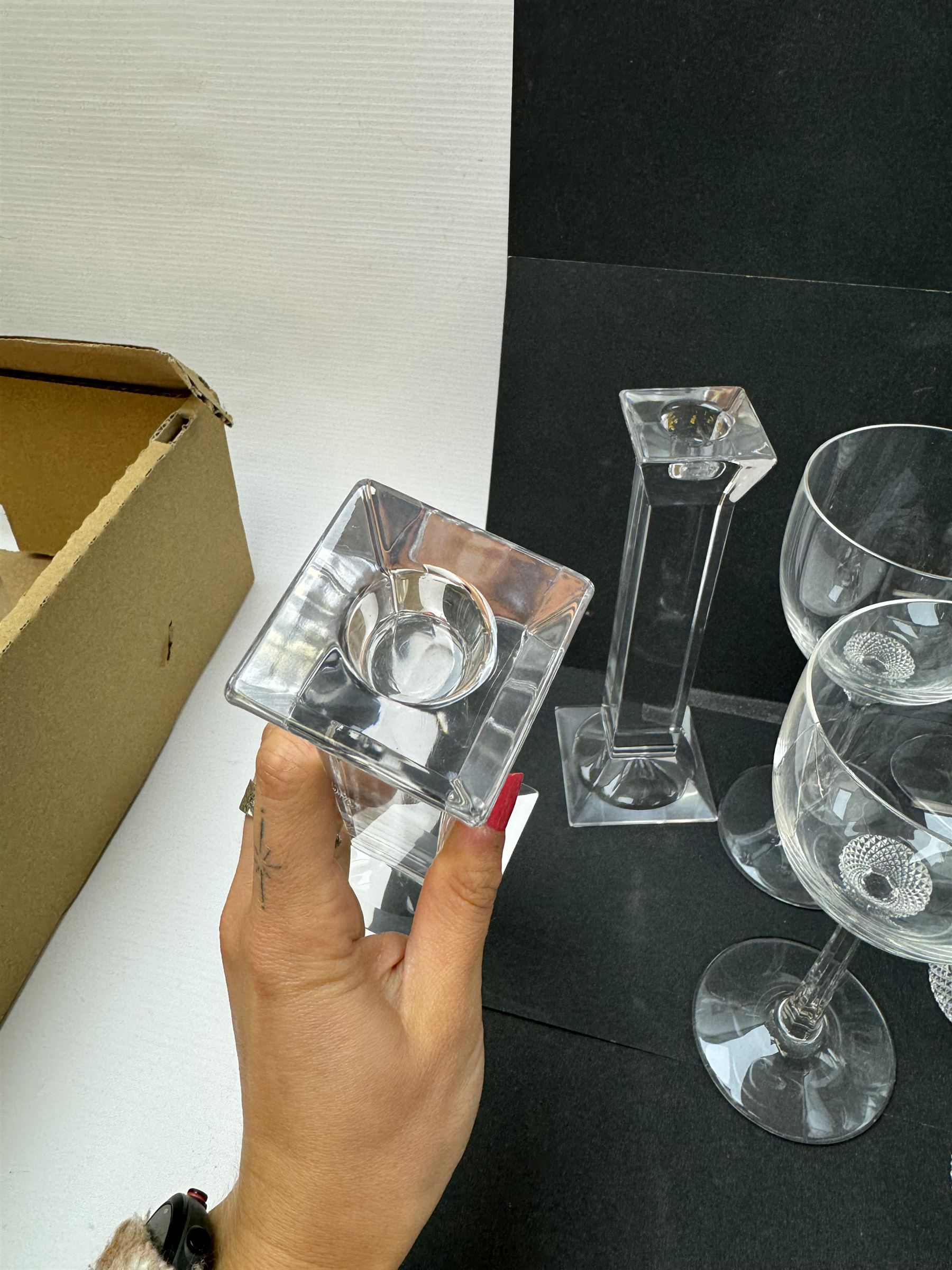 Twelve Villeroy & Boch Octavie glasses, to include six red wine glasses and six tumblers, each glass with hobnail cut decoration, together with a pair of Villeroy & Boch faceted glass candlesticks