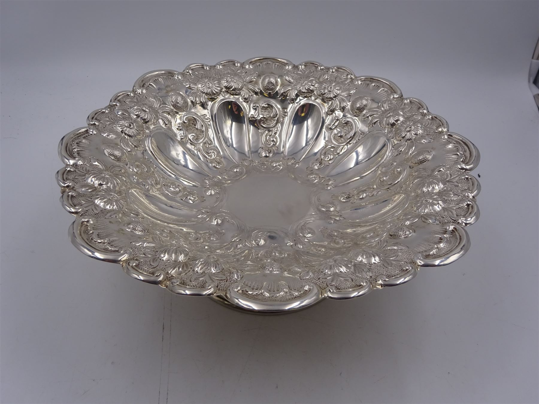 Edwardian silver pedestal bowl, of circular form, with shaped C scroll rim, embossed with floral and foliate decoration throughout, upon a circular foot, hallmarked Elkington & Co Ltd, Birmingham 1901, H9.5cm, D25cm