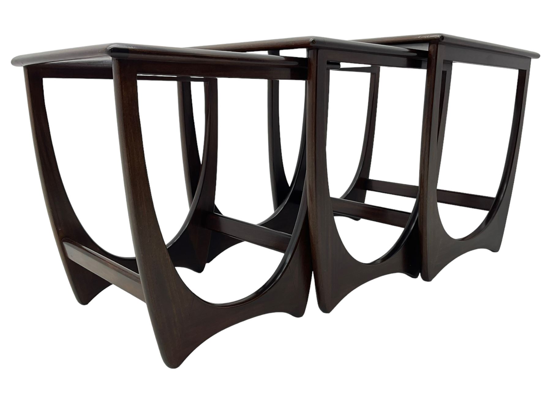 Mid 20th century teak nest of three tables, square tops with rounded edges, on curved supports with stretchers