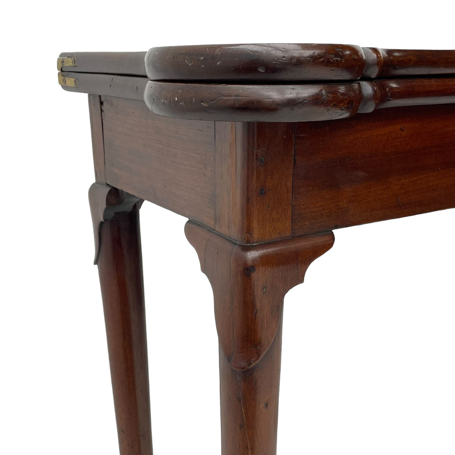 George III mahogany games table, the rectangular fold-over top with extending stepped rounded corners, opening to reveal baize lined interior with sunken counter wells, concertina action base, on lappet cabriole supports