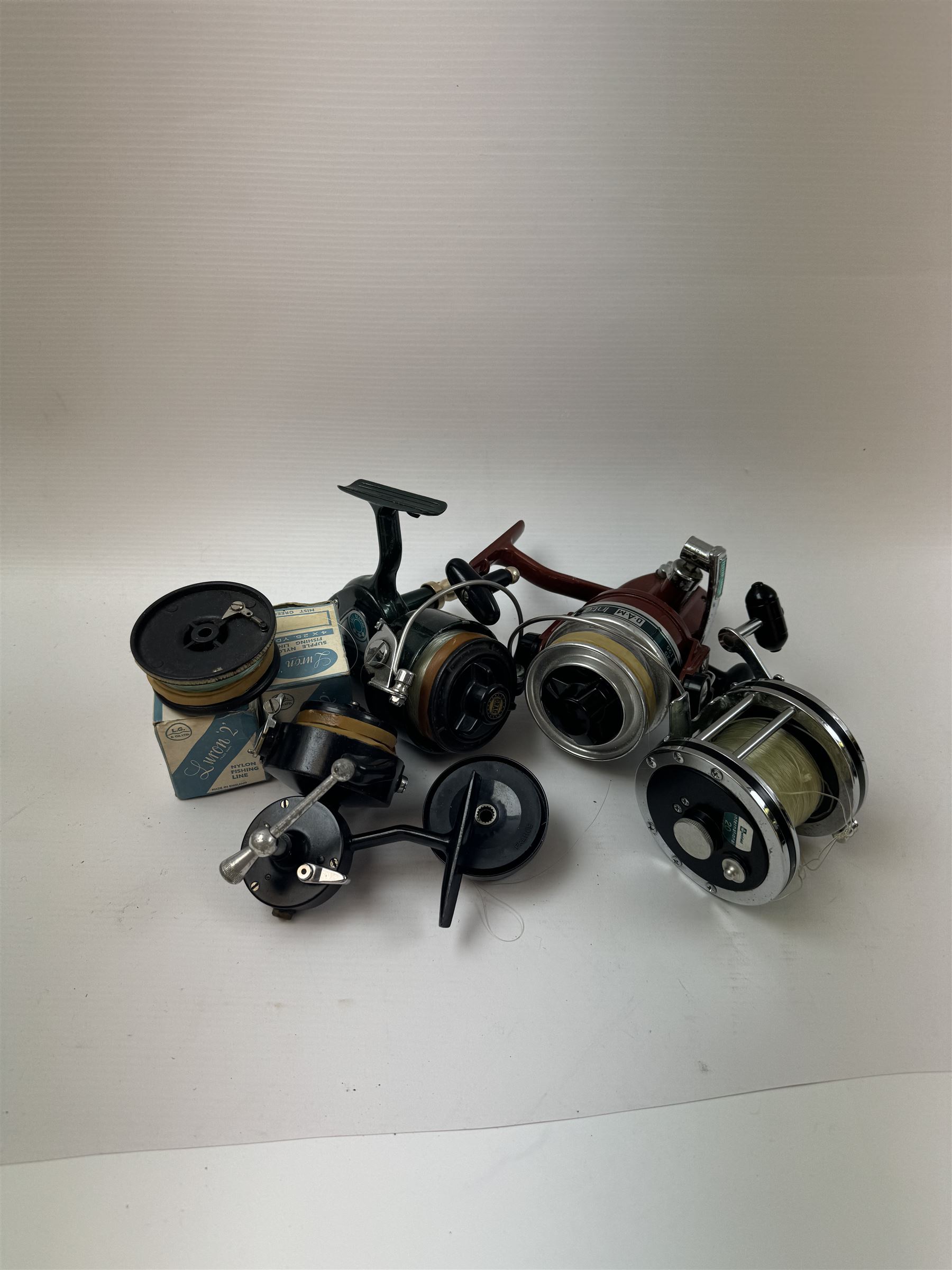 Four fishing reels, Winfield Beach fisher rod, Winfield International 20 , DAM International etc 