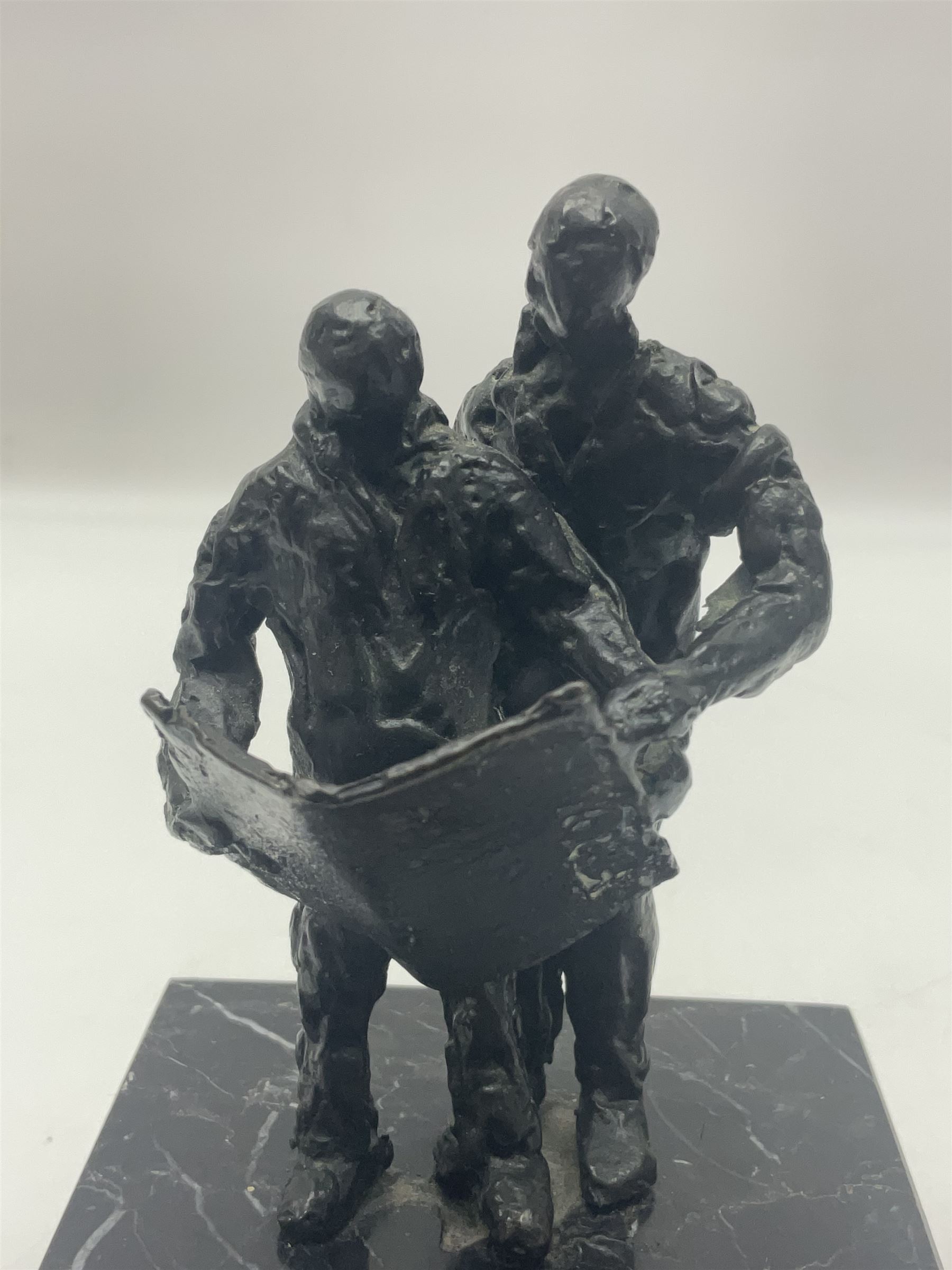 20th century bronze sculpture, modelled as two figures reading, upon a black and white marble base, H14cm