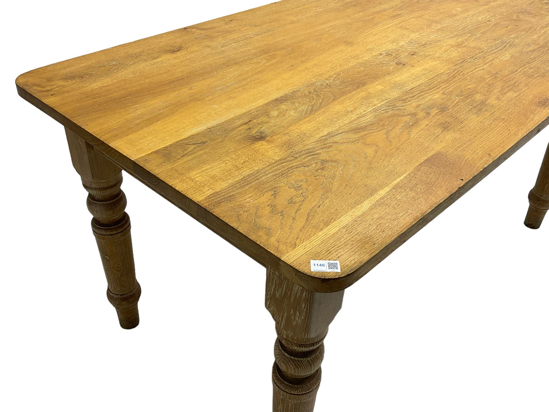 Limed oak dining table, rectangular top with rounded corners, on turned supports