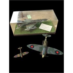 OEZ kitbuilt model of a 'Fishbed' Finnish aircraft, in ERTL display box, together with an Air Signature model of a Spitfire and a Corgi model of a Spitfire