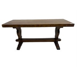 Solid oak coffee table, rectangular waved cut top with tooled ends, on shaped and pierced end supports joined by pegged stretcher 