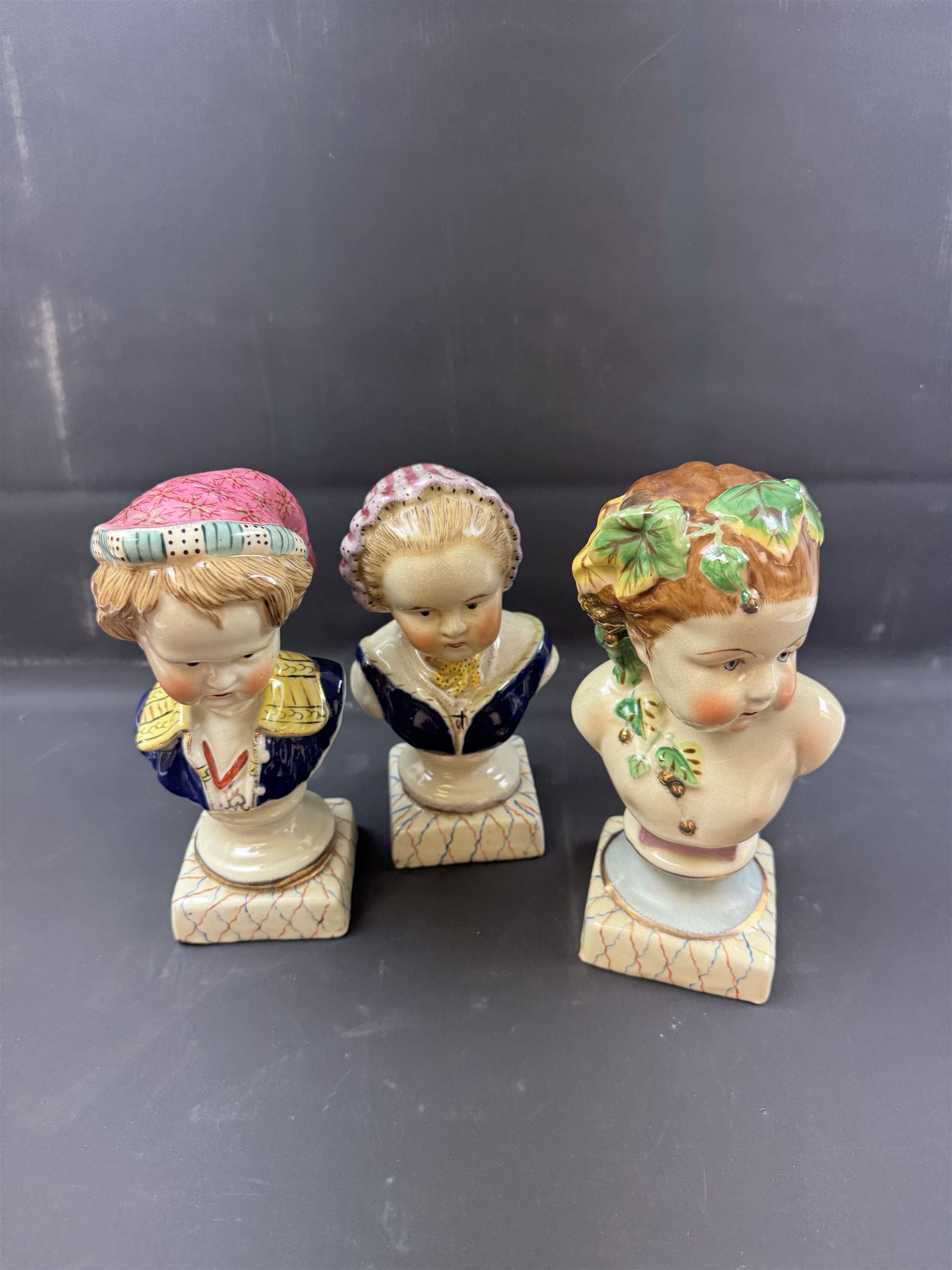 Pair or 20th century continental Bourbon children busts, together with another similar, H23cm