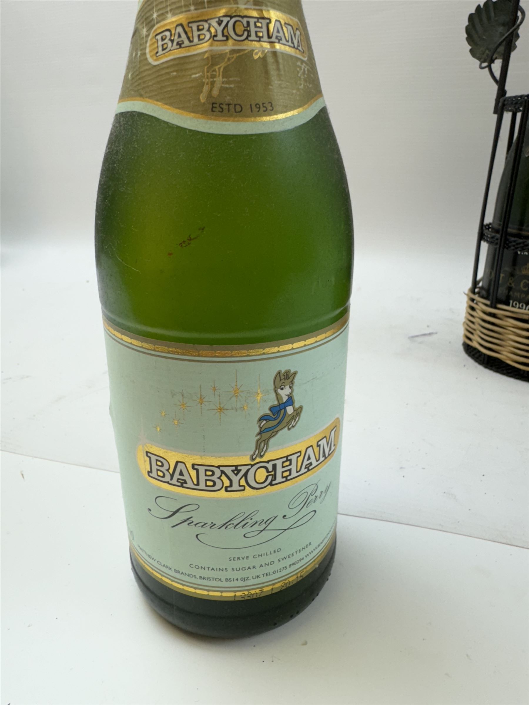 Moet & Chandon 1996 champagne, together with Babycham sparkling perry, in a wine holder, various contents and proof 