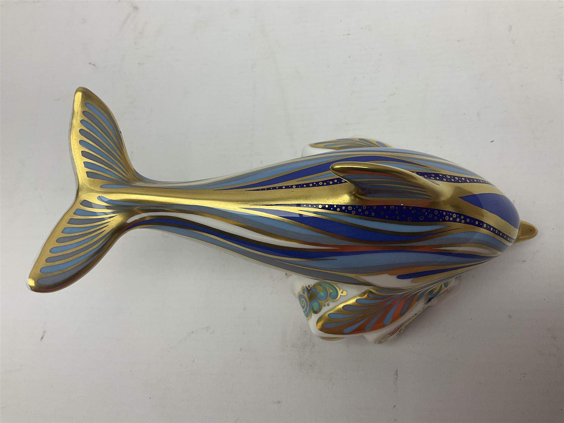 Three Royal Crown Derby paperweights, comprising Bottlenose Dolphin, Baby Bottlenose Dolphin and Striped Dolphin, all with gold stoppers 