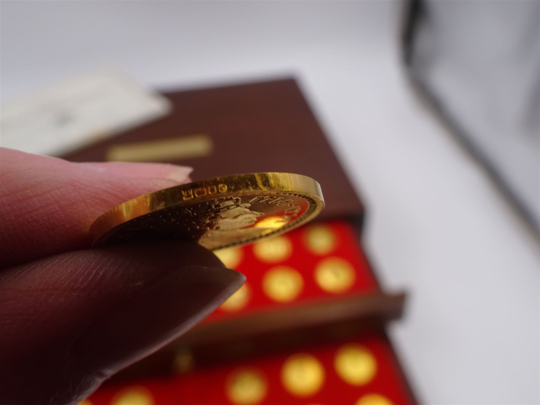 Danbury Mint, Our Royal Sovereigns Collection, seventy 22 carat gold plated silver medallions depicting the complete line of British monarchs to mark the 1200th anniversary of the first coronation, contained within wooden table top collectors cabinet with two drawers, with certificate of authenticity, with two drawers, hallmarked Danbury Mint, London various dates