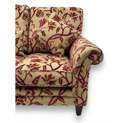 Contemporary upholstered three-seat sofa, scroll arms and loose cushions, embossed beige ground fabric with red and gold floral motifs, on tapered wooden supports